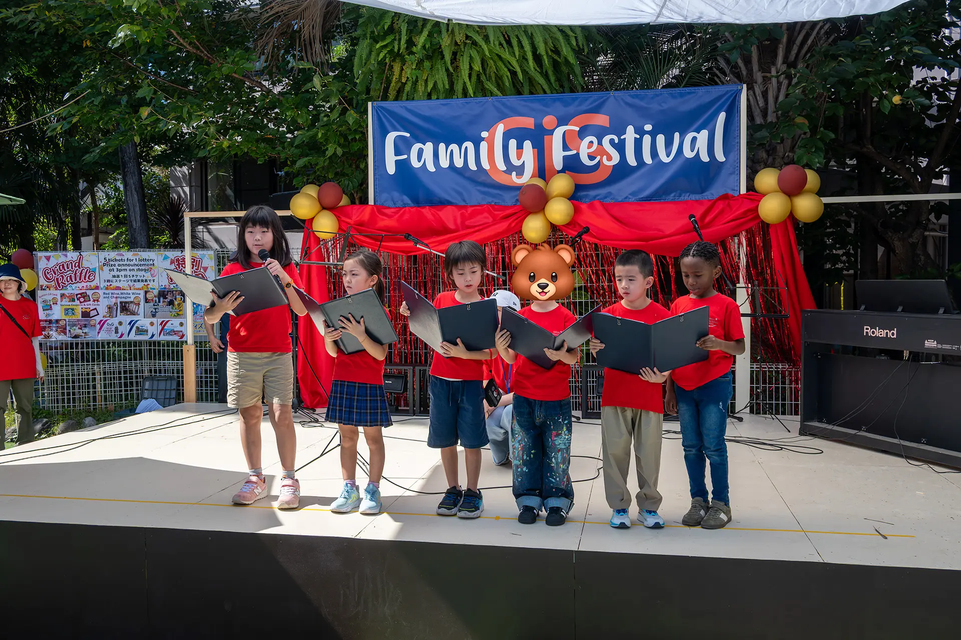 Photos capturing the GiS Family Festival, featuring student performances, fun activities, delicious food, and the wonderful school community coming together.